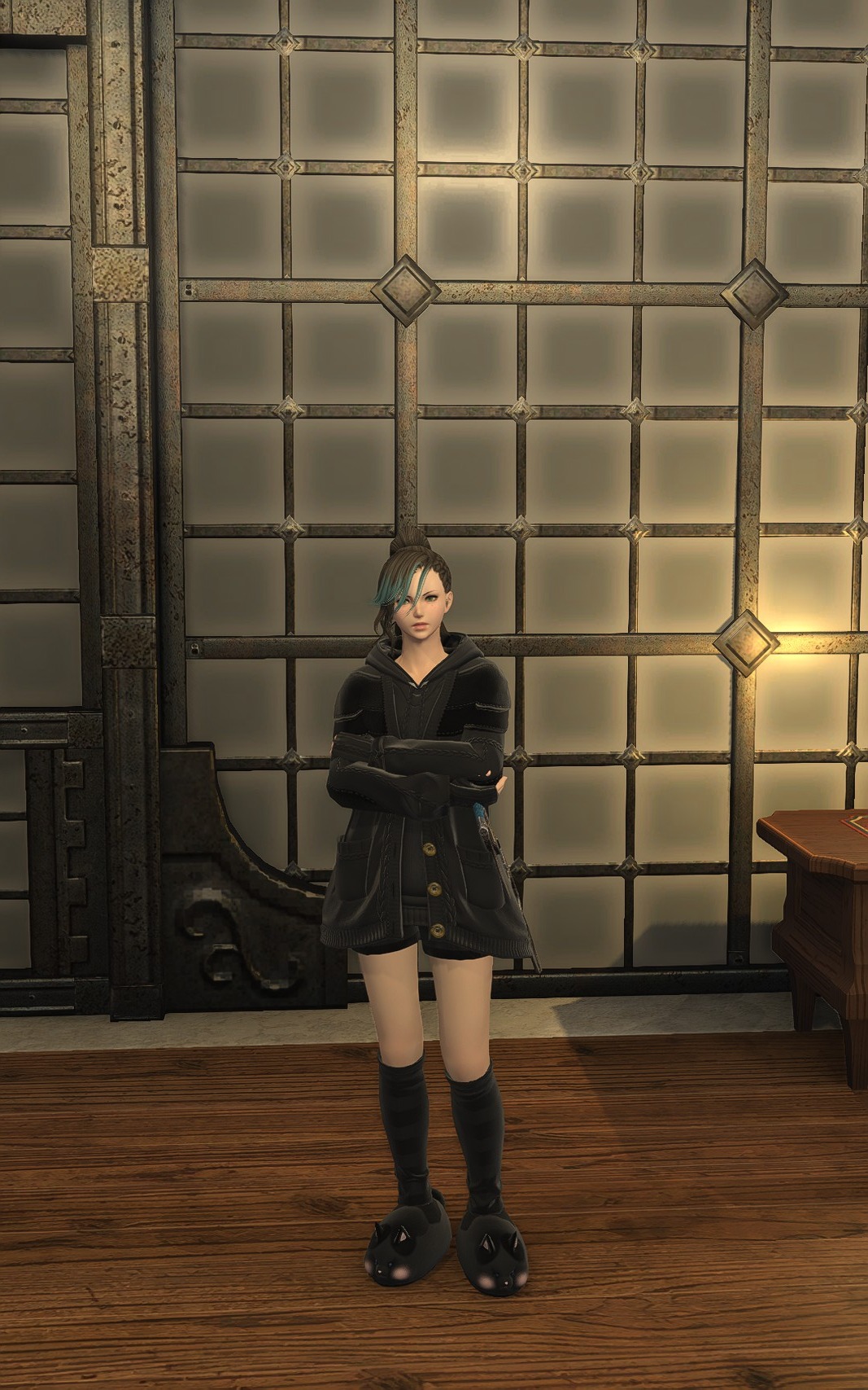 Aggro Phobic in an oversized black coat with black socks and paw-shaped slippers.