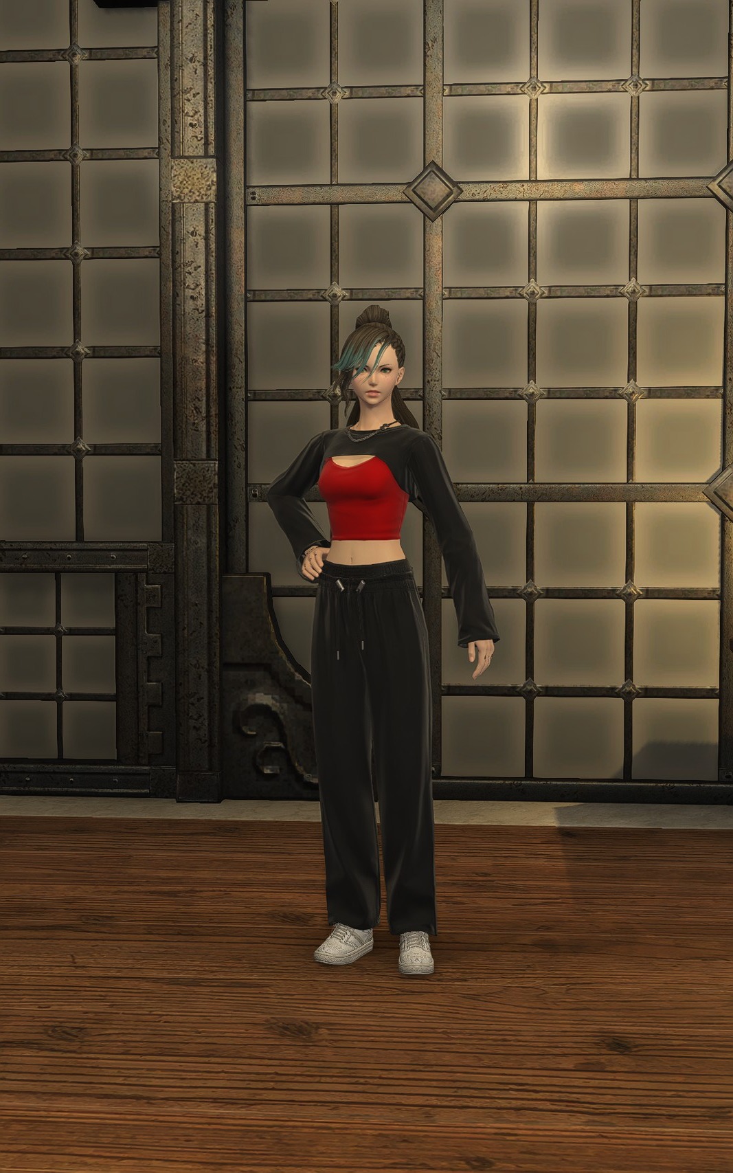 Aggro Phobic in a red crop top, black wide trousers and white trainers.